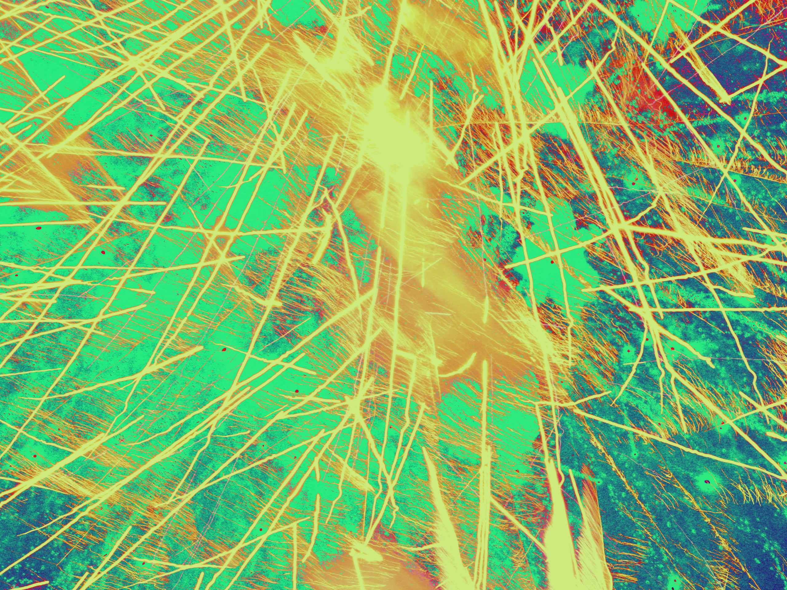 A photograph of water, heavily filtered, with a photograph of fireworks laid over it