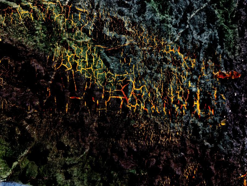 a stylized photograph of a painted wall overlaid on sand